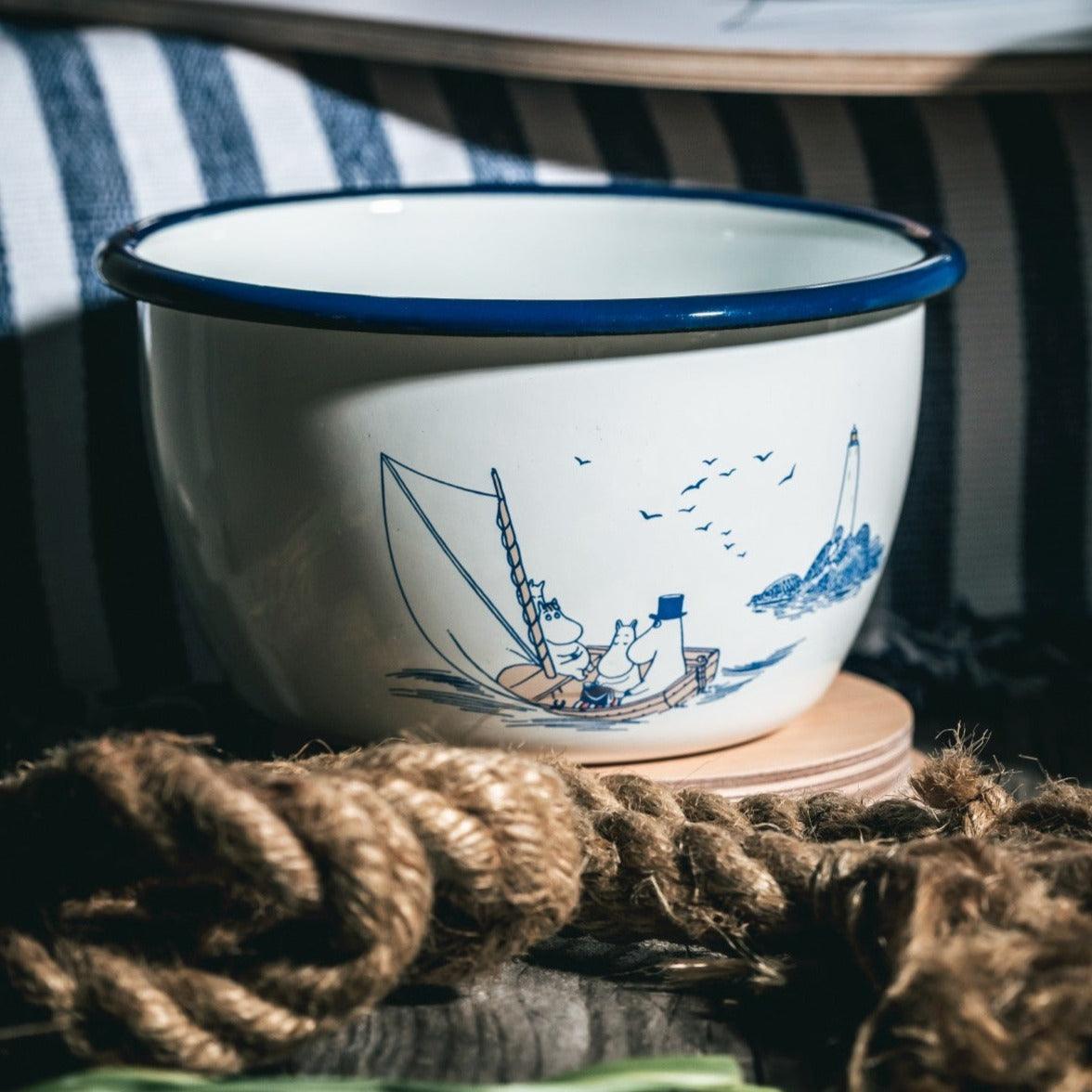 a blue and white bowl sitting on top of a table